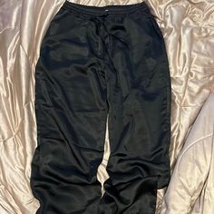 Never Worn Satin Jogger Pants Black High-waisted Parachute Pants For Night Out, Black Parachute Pants For Loungewear With Elastic Waistband, Black Parachute Pants For Loungewear, Casual High Waist Parachute Pants For Night Out, Black Parachute Pants For Night Out, Trendy Black Loungewear Pants, Casual Spring Parachute Pants For Night Out, Casual High-waisted Parachute Pants For Night Out, Casual Parachute Pants For Night Out In Spring