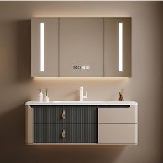 a bathroom vanity with two mirrors and lights on the wall next to it is illuminated