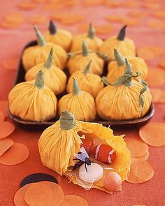 small pumpkins and gourds are arranged on a table