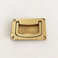 a gold door handle on a white surface