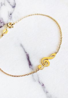 "14K 9K Gold Music Note Bracelet, Treble Clef Charm Bracelet, Dainty Music Note Bracelet, Solid Gold Bracelet, Musician Gift, Music Lover Gift, Christmas Gift, FREE EXPRESS SHIPPING Beautiful and delicate bracelet with a treble clef/note charm made in 14K or 9K solid gold. \"Music gives a soul to the universe, wings to the mind, flight to the imagination and life to everything.\" -- Plato Whisper...I love Music! -------------------------------------------------- D E T A I L S 14K Solid Gold or 9 Music-themed Bracelet Jewelry Gift, Music-themed Band Jewelry As Gift, Music-themed Band Jewelry Gift, Music Note Bracelet, Solid Gold Bracelet, Musician Gifts, Gold Designs, Bracelet Dainty, Treble Clef