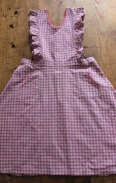 FRENCH VINTAGE 50's, lovely pinafore dress / apron dress, pink and blue checkered cotton fabric, red trim edges, wide open sleeves, two patch pockets, buttoned down the waist ( glass buttons ). Estimated size 9 years : Length 32,3" New old stock ( washed once ) In case of multiple purchases, if you want an accurate shipping estimation, please contact me ; I do always refund overcharged shipping from 1 Euro overpaid ! Thank you for your visit Cotton Gingham Plaid Dress With Ruffles, Gingham Plaid Cotton Dress With Ruffles, Retro Gingham Plaid Cotton Dress, Retro Cotton Plaid Dress For Picnic, Vintage Cotton Pinafore Dress With Pockets, Cotton Plaid Ruffled Dress For Picnic, Retro Cotton Plaid Dress, Cotton Plaid Dress With Ruffles For Picnic, Pink Cotton School Dress