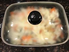 a pot filled with soup sitting on top of a counter next to a black stove