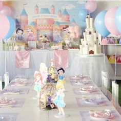 a table set up for a princess birthday party with balloons and paper plates on it