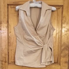 New York & Company Beautiful Sleeveless Top. Stretch Side Tie Stiched (Not Adjustable) Color Tan Size Medium Length 24" Pit/Pit 18" Waist 32 New Without Tags Bundle Items And Save! Casual Sleeveless Tops With Tie Waist, Chic Sleeveless Top With Tie Waist, Fitted Sleeveless Top With Tie Waist, Beige V-neck Tank Top For Work, Fitted Sleeveless Tie Waist Tops, Elegant Sleeveless Tops With Tie Waist, Spring Sleeveless Top With Tie Waist, Sleeveless Tie Waist Top For Spring, Sleeveless Tops With Tie Waist For Spring