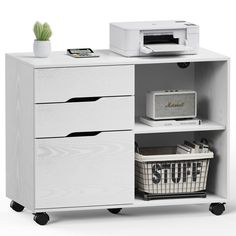 a white cabinet with three drawers and a printer on the top shelf next to it