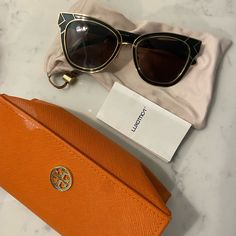 Like New Tory Burch Sunglasses. Original Sleeve And Case. Case Is Slightly Stained But Perfectly Fine Other Than That. Gold Polarized Cat Eye Sunglasses For Formal Occasions, Elegant Travel Sunglasses With Mirrored Lenses, Elegant Mirrored Sunglasses For Travel, Elegant Glass Sunglasses For Travel, Chic Gold Cat Eye Sunglasses With Glass, Elegant Gold Cat Eye Sunglasses With Glass Lenses, Elegant Gold Cat Eye Sunglasses With Glass Material, Modern Tortoiseshell Sunglasses With Uv Protection, Designer Tortoiseshell Sunglasses With Uv Protection