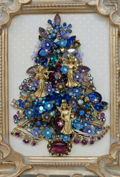 a christmas tree made out of beads and other items in a gold frame with polka dots