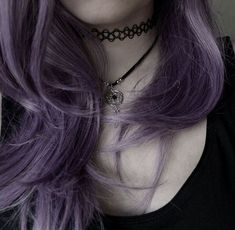 a woman with long purple hair wearing a choker and black necklace on her neck