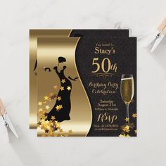 an elegant 50th birthday party with gold stars and black dress on the front, champagne in the background