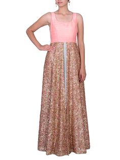 This layered gown is a unique combination of sleeveless peach raw silk kotha and center front cut layer and silk grey skirt beneath. This is a sleeveless pattern with an open round back. To complete the look, the whole garment is accessorized by the layer that is filled entirely with sequin and thread embroidery.Care:Dry Clean Only and to be Steam PressedComposition:Raw silk and silk