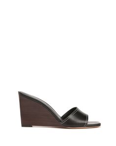 Timeless, understated, chic—the Ellen sandal is a peep-toe mule with a stacked wooden wedge heel. Crafted from smooth leather with contrast stitching, it has an on-trend Nineties feel. The cushioned footbed and slip-on style ensure easy wear, and the polished silhouette pairs well with dresses and jeans alike.Leather 3.25” heel Store in a cool, dry place inside dust bag Clean under the supervision of a specialist Style # J0044L1 Wooden Wedges, Black Wedge Sandals, Sweaters And Jeans, Veronica Beard, Wedge Sandal, Jeans For Sale, Sneaker Shopping, Shoe Sale, Easy Wear