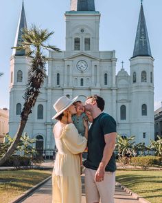 a man and woman standing in front of a church