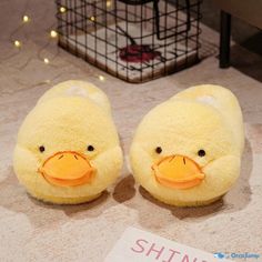 two yellow stuffed animals sitting on top of a floor