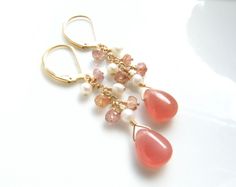 Gorgeous and flawless natural rhodochrosite gemstones are the focal point for these delicate dangle earrings. Accented with white freshwater pearls and rhodochrosite stones cascading down a gold filled chain. Perfect for women who love coral pink hues and elegant dainty jewelry. Earring Details: - Earring length with earring closures shown is 1.75 inches (4.44 cm) - Rhodochrosite teardrop stones are 10 mm long by 6.5 mm wide (.45 inches tall) - Fine Heart jewelry is handmade and custom fitted fo Pink Natural Stones Wedding Earrings, Wedding Pink Earrings With Natural Stones, Bridal Party Jewelry, Soft Coral, Stone Dangle Earrings, Handmade Fine Jewelry, Jewelry Earring, Earrings In Gold, White Freshwater Pearl