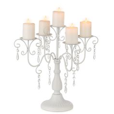 a white candle holder with five candles in it