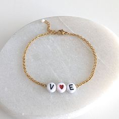 A dainty and minimalist chain bracelet for women to claim your love ! * YOU+ME *  by Studio MND90 HANDCRAFTED WITH LOVE & CARE ------------------------------------------------- - Acrylic initial letter and heart beads - 18K Gold plated stainless steel chain - 1.18 in (3 cm) chain extender DIMENSIONS ------------------ Length : adjustable from 6.30 in (16 cm) to 7.48 in (19 cm) QUICKLY DISPATCHED ! --------------------------------- Shipping within 1 business day with tracking number. Free standar Valentine's Day Gold Name Bracelet With Letter Beads, Gold Bracelets With Initials For Valentine's Day, Personalized Gold Chain Bracelet For Valentine's Day, Dainty Heart-shaped Adjustable Name Bracelet, Gold Heart-shaped Name Bracelet With Letter Beads, You Me, Minimalist Chain, Bracelet Initial, Bracelet Minimalist