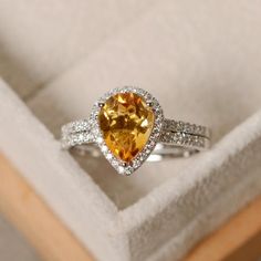 This halo ring features a 7*9mm pear cut natural citrine and sterling silver finished with rhodium. Customization is available. It is made by hand, and it will take about 7 days to finish the ring after your payment is completed. Main stone: genuine citrine Citrine weight: Approx 1.90 ct Metal type: Citrine Engagement Rings, Citrine Ring Engagement, Gold Diamond Wedding Rings, Fake Wedding, August Wedding, Engagement Ring White Gold, Jewelry Style, Citrine Ring, Natural Citrine