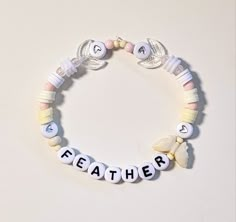 a white bracelet with letters that spell out the word,'father'on it