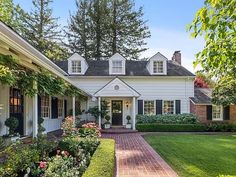 a white house surrounded by lush green trees