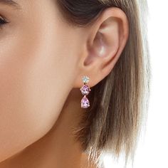 These gorgeous two-toned drop earrings feature over 7 carats of sparkling pink morganite in two shapes, dangling from brilliant white diamond tops set in 18k gold! The perfectly matched, crystalline gem morganites have beautiful, bright pink color and are set in 18k pink gold baskets that dangle below a lovely arrangement of fine white diamonds. The diamond tops were formed by encircling a single princess cut diamond with marquise shaped diamonds, creating the illusion of a single large diamond! Formal Pink Diamond Earrings, Elegant Pink Diamond Earrings With Accents, Pink Diamond Earrings With Accents, Elegant Pink Diamond Earrings, Fine Jewelry Pink Diamond Earrings For Formal Occasions, Pink Diamond Earrings For Formal Events, Fine Jewelry, Pink Diamond Earrings For Formal Occasions, Pink Diamond Drop Earrings In Fine Jewelry Style, Pink Diamond Drop Earrings Fine Jewelry