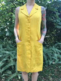 Vintage 60's Yellow Shift Style Dress Button Down Closure with Hidden Buttons Inside Lined in Silky Rayon (Nice in Warmer Climates for Cooling Effect) Condition: Vintage - Great (No Visible Markings/Holes) Brand: Sàke Size: Marked Size 10 - Would Suggest for a Modern S/M Measurements (Taken While Laying Flat): Bust: 18 1/2 Inches Waist: 17 Inches Hips: Free Retro V-neck Dress With Buttons, Vintage Knee-length Mini Dress With Button Closure, Retro V-neck Dress With Button Closure, Mod Sleeveless Dresses With Buttons, Retro Summer Mini Dress With Buttons, Retro Sleeveless Vintage Dress With Buttons, Sleeveless Retro Vintage Dress With Buttons, Knee-length Buttoned Vintage Fashion Dresses, Vintage Dress With Button Closure For Vintage Fashion