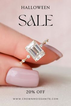 a woman's hand holding an engagement ring with the words halloween sale on it