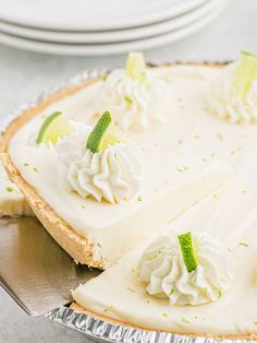 a pie with limes and whipped cream on top