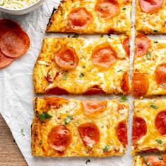 pepperoni pizza cut into squares on top of paper