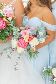 the bridesmaids are holding their bouquets together