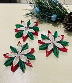 three christmas decorations are sitting on a table