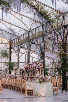 an indoor wedding setup with tables and chairs