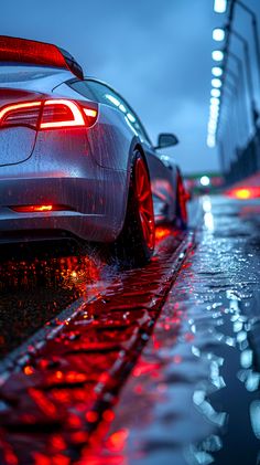 the back end of a car parked on a wet street at night with red lights