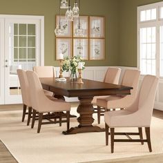 a dining room table with chairs and chandelier