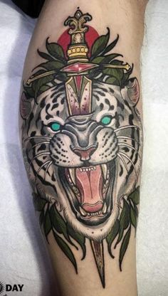 a tiger with a crown on it's head and an arrow in its mouth