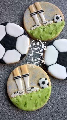 four decorated cookies with soccer balls and socks on them