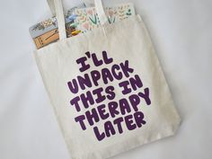 item: "i'll unpack this in therapy later" tote bag why you'll love it:this tote is perfect for normalizing therapy and letting everyone know that you'll be unpacking the weight of the world with your therapist soon. if you could see it IRL:heavyweight, single-sided canvas tote with purple screen-printed design, made of recycled materials. At widest points, tote is 15" wide and 16" tall, and expands to 3". Handles have a 10" drop. All products sold by KynYouBelieveIt are designed, made, and packa