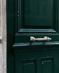 a green door with a rope on it