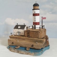 a small wooden boat with a lighthouse on top