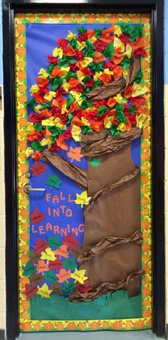 a bulletin board decorated with paper flowers and the words fall into learning written on it