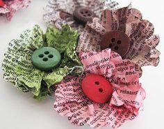 three different types of fabric flowers with buttons on them, one is green and the other is pink