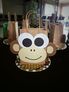 there is a paper bag with a monkey on it and some bags in the background