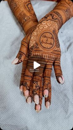 the hands and feet of a woman are decorated with henna designs on her hand