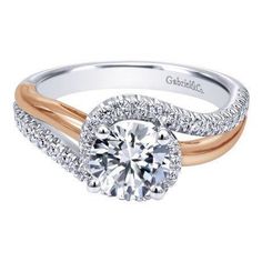 an engagement ring with two tone gold and white diamonds on the band, featuring a round center