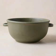 a green bowl sitting on top of a table