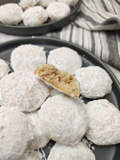 some snowball cookies are on a plate