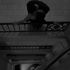 a woman standing on top of an escalator