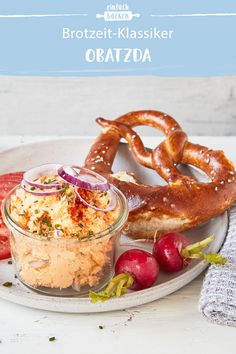 a white plate topped with pretzels and other food items next to a bagel