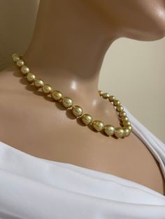 Deep Gold South Sea Pearl Necklace. This hand knotted necklace features 39 Deep Gold South Sea Pearls AA+-AAA High Luster Drop Shapes 8.1-11.4mm. These pearls are Genuine and Natural in color. Some of the pearls have some light surface blemishes. I hand knotted this necklace with gold silk thread and finished it with a 14K Yellow Gold 9mm round polished bead clasp. The necklace measures 18 1/2 inches in length. These deep gold South Sea Pearls and the most sought after of pearls. The necklace pi Classic Evening Pearl Necklace With Round Beads, Classic Pearl Necklace For Evening, Elegant Yellow Pearl Necklace For Formal Occasions, Formal Pearl Beaded Necklaces With Round Beads, Classic Beaded Pearl Necklace For Evening, Elegant Formal Beaded Necklaces With 8mm Beads, Elegant Yellow Round Bead Necklaces, Evening Pearl Necklace With Round Beads, Beaded Pearl Necklace With Round Beads For Evening