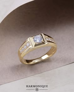 a yellow gold ring with diamonds on it